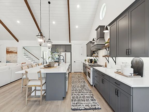 Kitchen with vaulted ceiling and pendant lighting