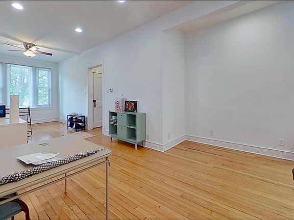 Big open living room, recessed lighting and fan faces west on Southport Street