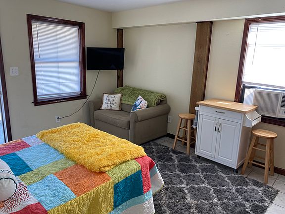small couch with tv & bar stool with seating
