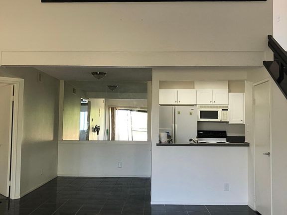 Living room, kitchen, and a view to the upstairs den