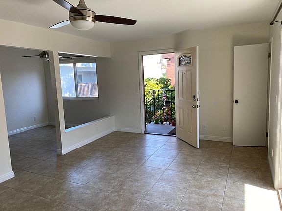 Entrance with storage closet and sliding door on right and breakfast nook on left.