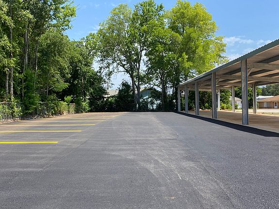 Covered parking with extra spaces, across the side street from building
