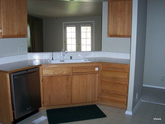 Large kitchen with lots of counter space and lighting. Newer refrigerator and dishwasher.