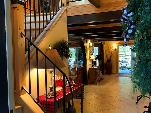 At the entrance is the staircase to upper level and opens to the flow of the first floor and view to the lake.