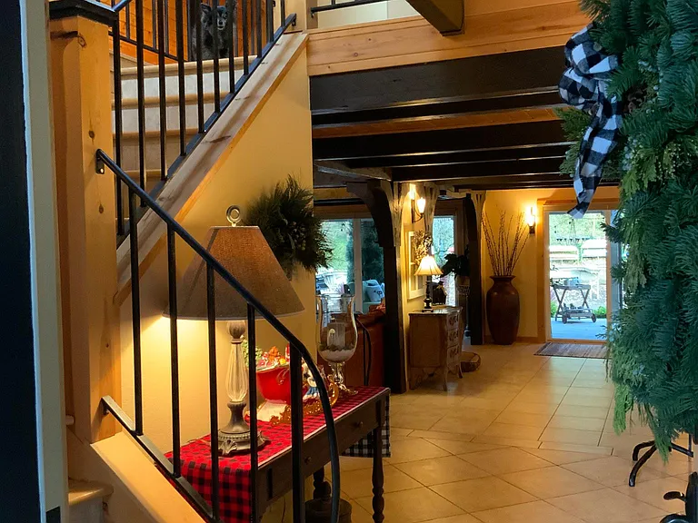At the entrance is the staircase to upper level and opens to the flow of the first floor and view to the lake.