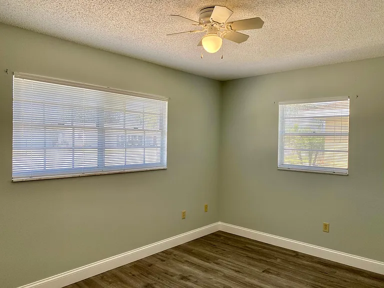 Guest bedroom with ample natural light.