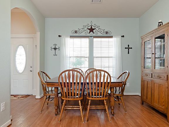 Just off the foyer and open to the kitchen is this bright & cheery dining area with hand-scraped woo