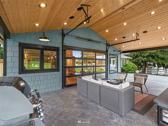 Check this out! A {12 FOOT GLASS DOOR} Opens to Exterior creating INDOOR/OUTDOOR LIVING! This unites the open living space, kitchen and dining room to a covered deck. It's INCREDIBLE!