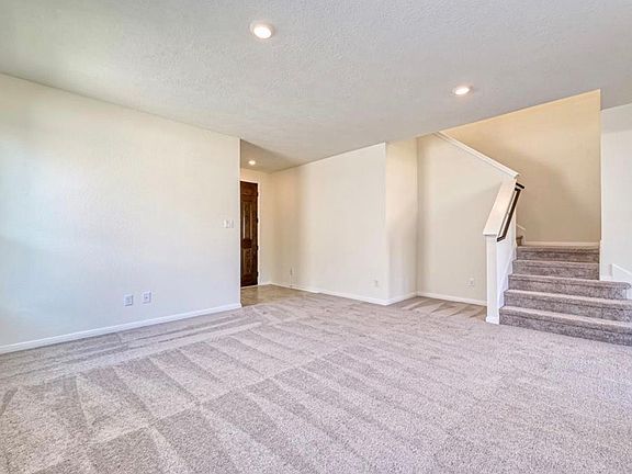 Step into a welcoming foyer with a beautiful staircase that leads to the spacious bedrooms and versatile upstairs game room