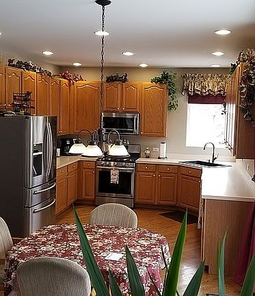 Kitchen w/tall oak cabinets