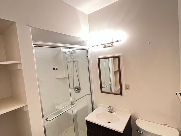 Bathroom with recently installed shower with Basco door