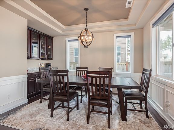 Formal dining room with cabinets and coffered ceiling