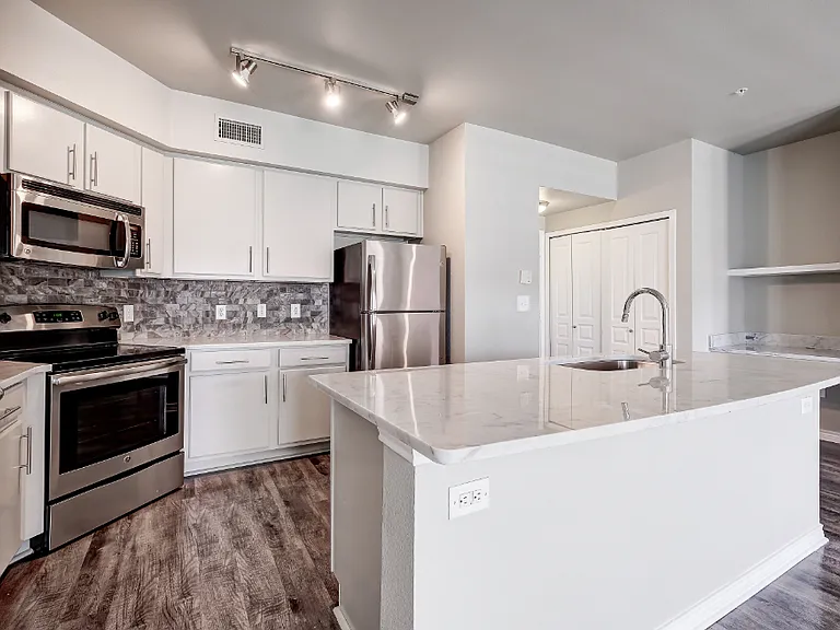 Kitchen with stainless steel appliances and built-in work desk