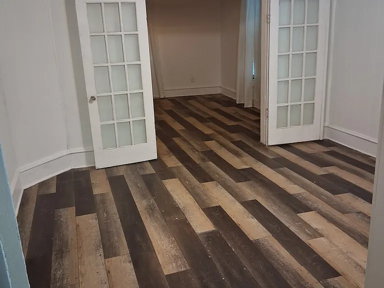 middle bedroom with French doors open to front bedroom