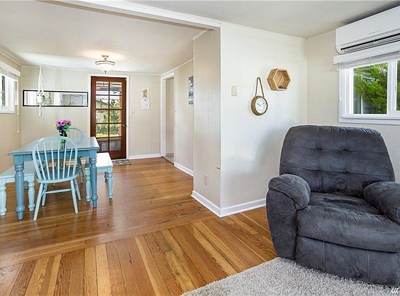 Dining room off the living room and kitchen with a french door to the back covered deck.