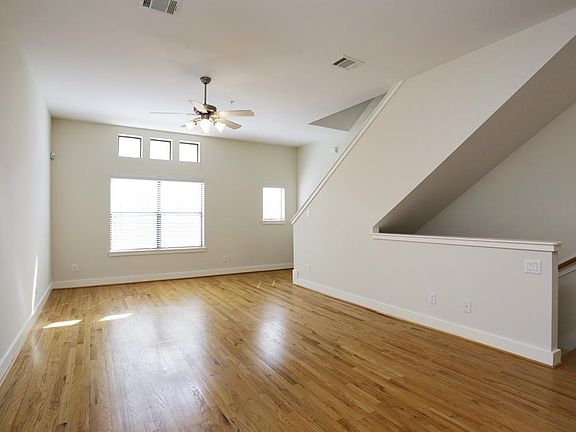 2nd floor living area with hardwoods, high ceilings and great natural light