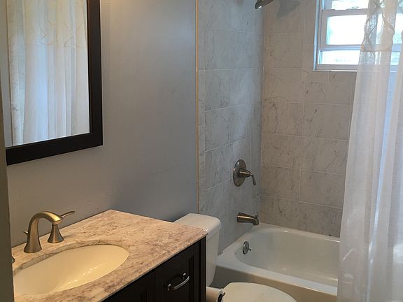 newly tiled bath w glass border,vanity w marble top