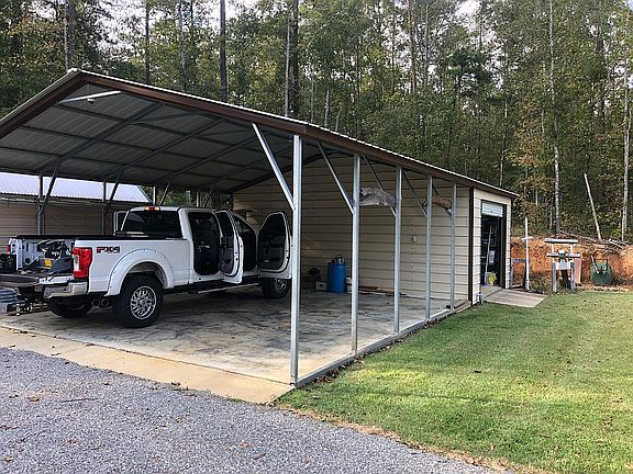 Storage bldg w/ dbl carport
