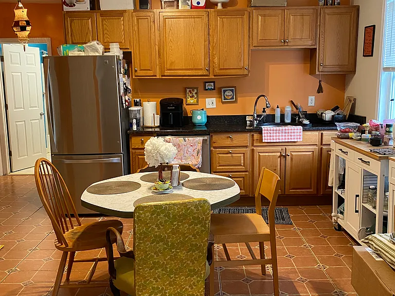 Eat-in kitchen has refrigerator, stove, microwave, disposal, built-in AC, ceramic tile floor, granite countertops.