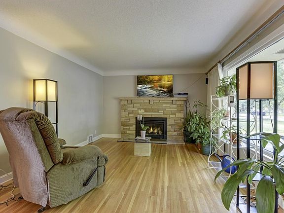 Living room with cozy gas fireplace, and large windows