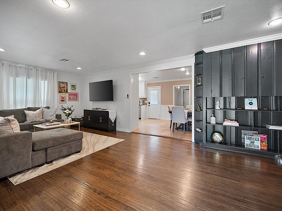 Open area Living area with gleaming hardwood floors.