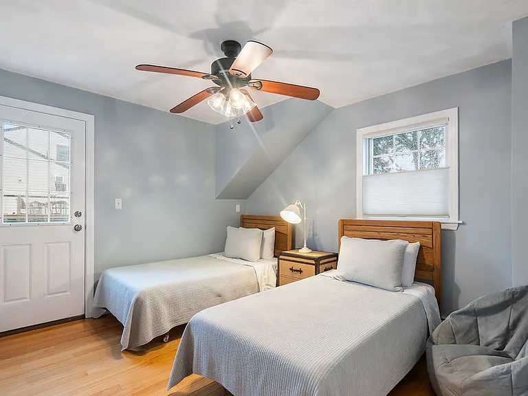 Third bedroom has two single beds, clothes storage and access to a small balcony
