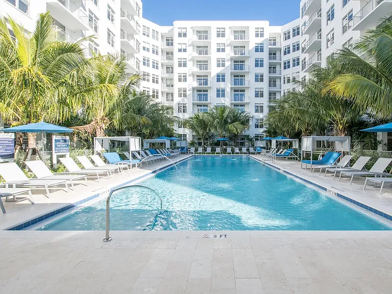 Swimming pool and sundeck with cabanas and lounge seating. Gazebo with flat screen TV.