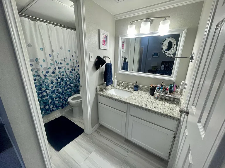 master bathroom with sink and additional vanity space, separated bath/toilet area