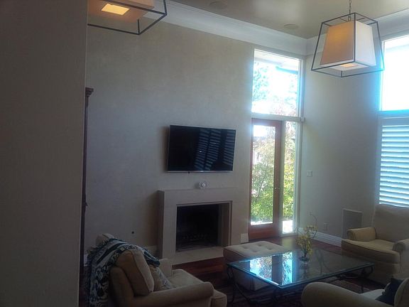 Hand-carved limestone fireplace with hardwood floor and inte