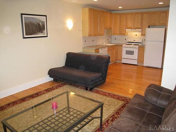 Open Living Room with hardwood floors. Room is 18' x 13' plus kitchen that is 11'- x 7'
