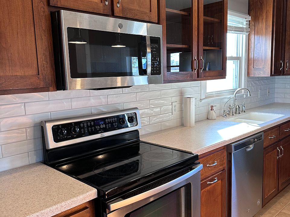 Custom Floor to ceiling cabinetry, new subway tile backsplash, stainless steel appliances