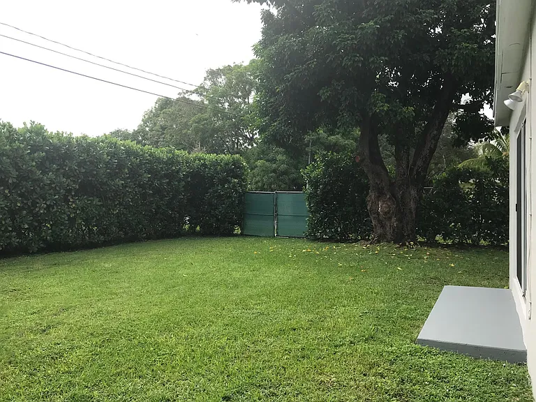 Another view of the fenced, private backyard with additional double-wide gate.
