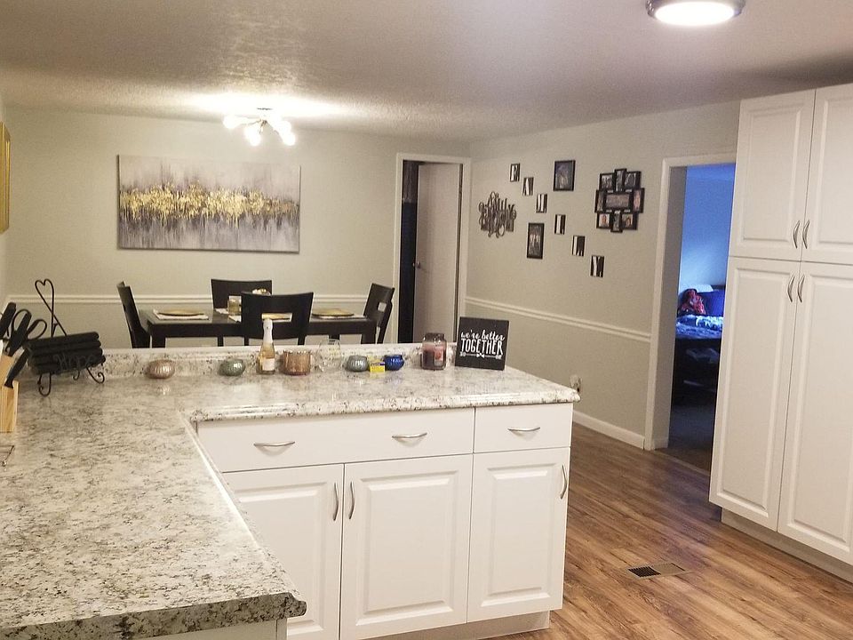 Kitchen with previous flooring. Now new tile throughout. This picture shows open floor plan.