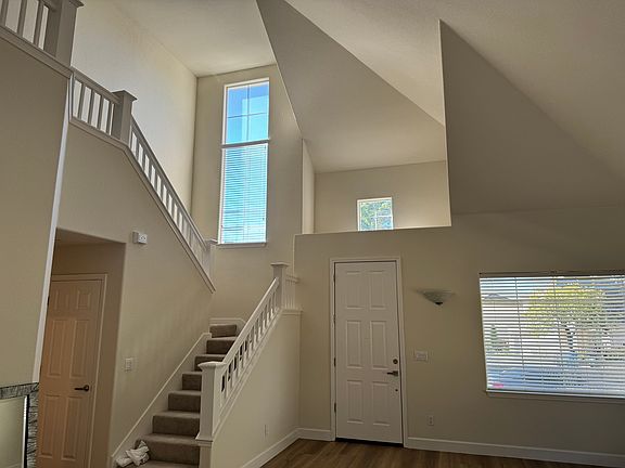 View of stairs and vaulted ceiling