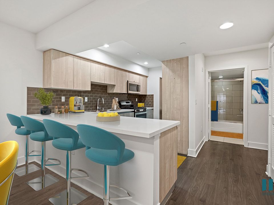 Kitchen with Countertop Bar and Stainless-Steel Appliances