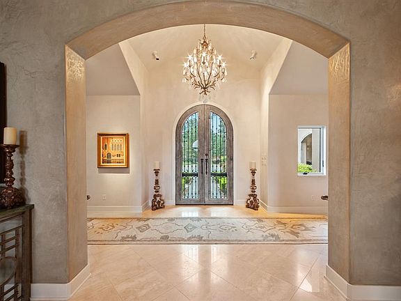 Gorgeous entry with Canterra doors, Travertine floor, and art niches.