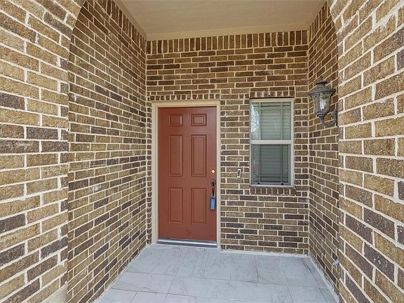 Entrance to property featuring brick siding