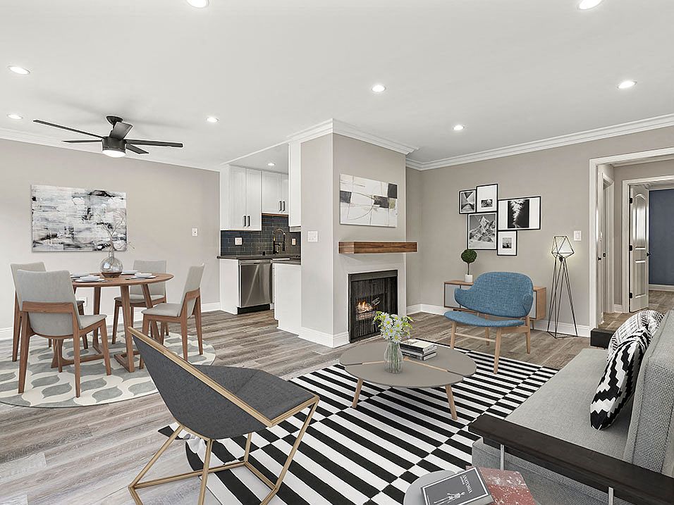 Living room with hardwood floors and view of dining room and kitchen.