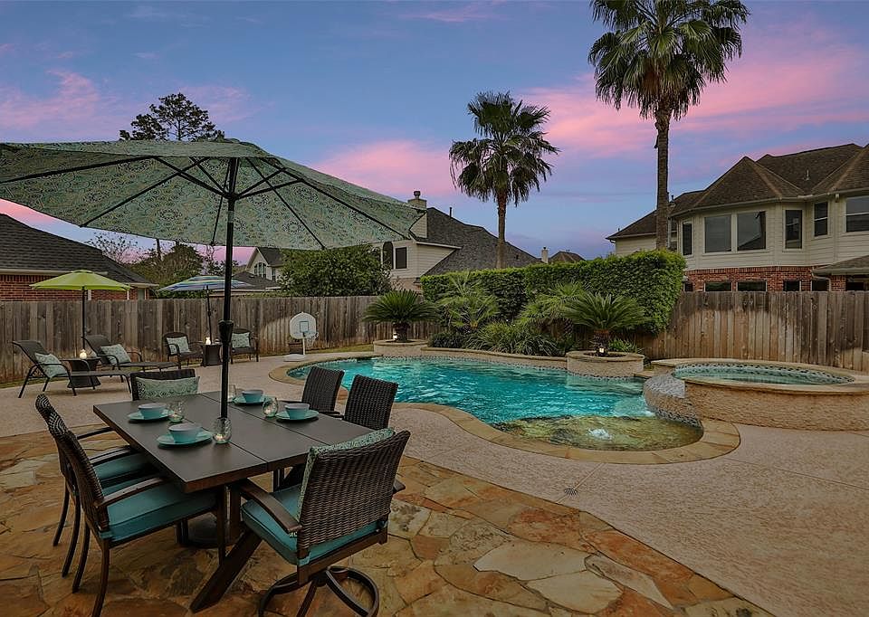 Wow! The pool is ideally situated off to one side of the 9,359 square foot lot. Sunset casts a serene glow over the custom pool/spa and flagstone patio.