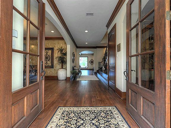 The grand double door entry opens onto a fabulous reception area, complete with hardwood flooring, a beautiful iron staircase, & stately crown millwork.