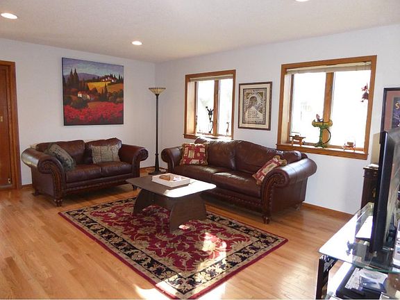 BALANCE OF BEAUTY & COMFORT Livingroom with rich hardwood floors flows into the Dining & sun room
