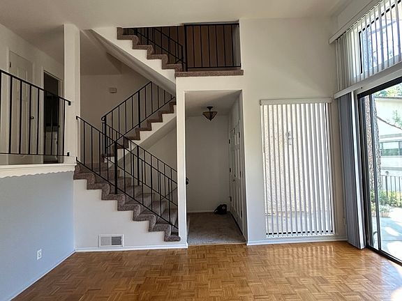 Downstairs living area with view of staircase