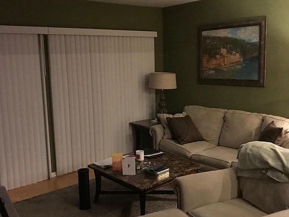 LARGE LIVING ROOM WITH WOODBURING FIREPLACE ACCESS TO PATIO/