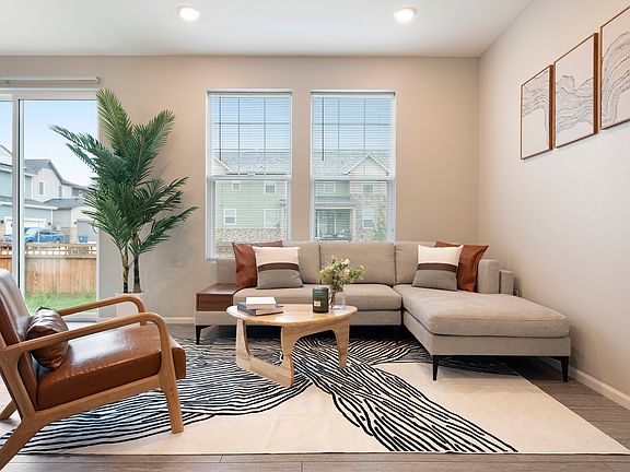 Bright, stylish living room with natural light, cozy sofa, modern decor, and spacious layout. Perfect for families & travelers. Near parks, DIA and hospitals. Book your comfortable stay today!