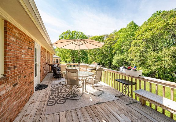 Deck overlooks woods at the edge of the yard