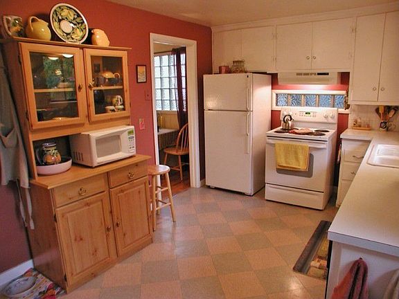 Generous kitchen has room for a table. Laundry area is also in the kitchen.