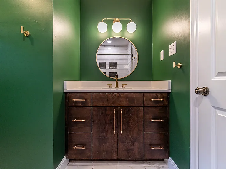 Upstairs full bath in the hall with custom vanity.