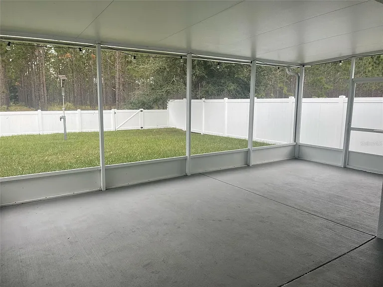 Spacious enclosed patio and fully fenced in yard overlooking conservation.