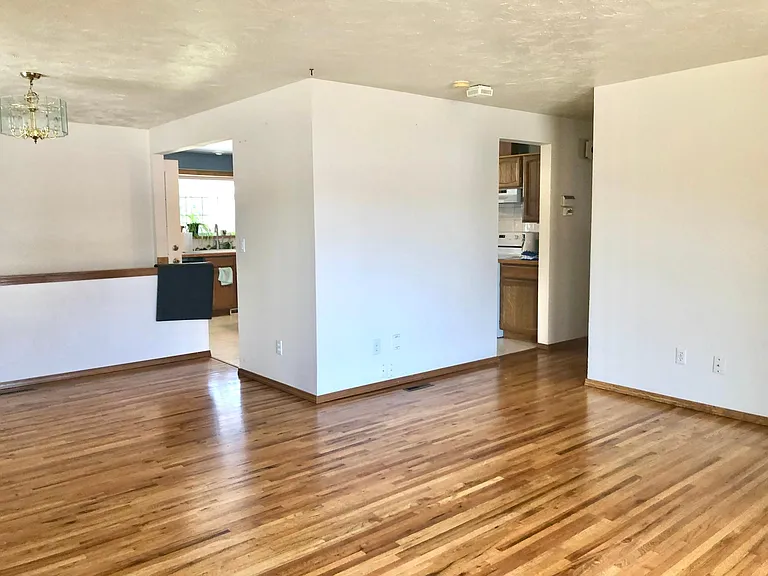 From the living room, looking toward dining and kitchen. Both doors lead into the kitchen.