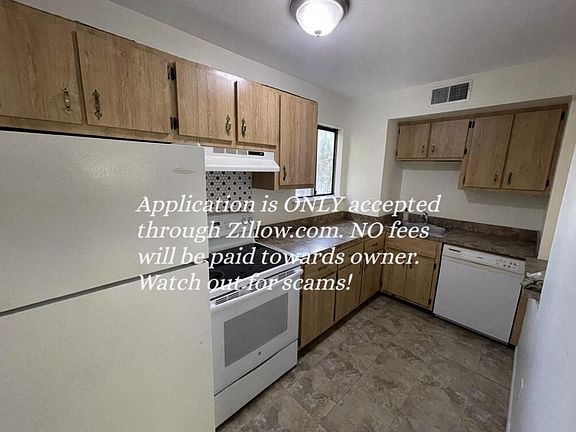 Kitchen is fully functional with electric stove, fridge and dish washer